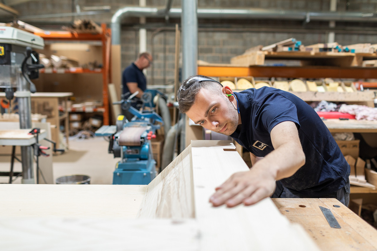 man checking wood quality