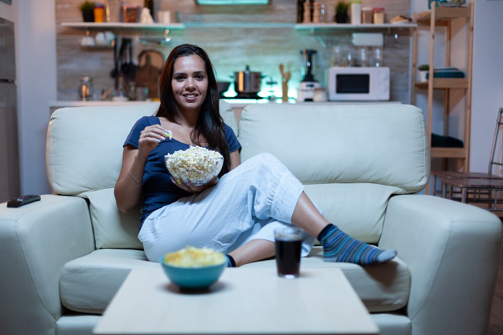 woman watching movie on sofa